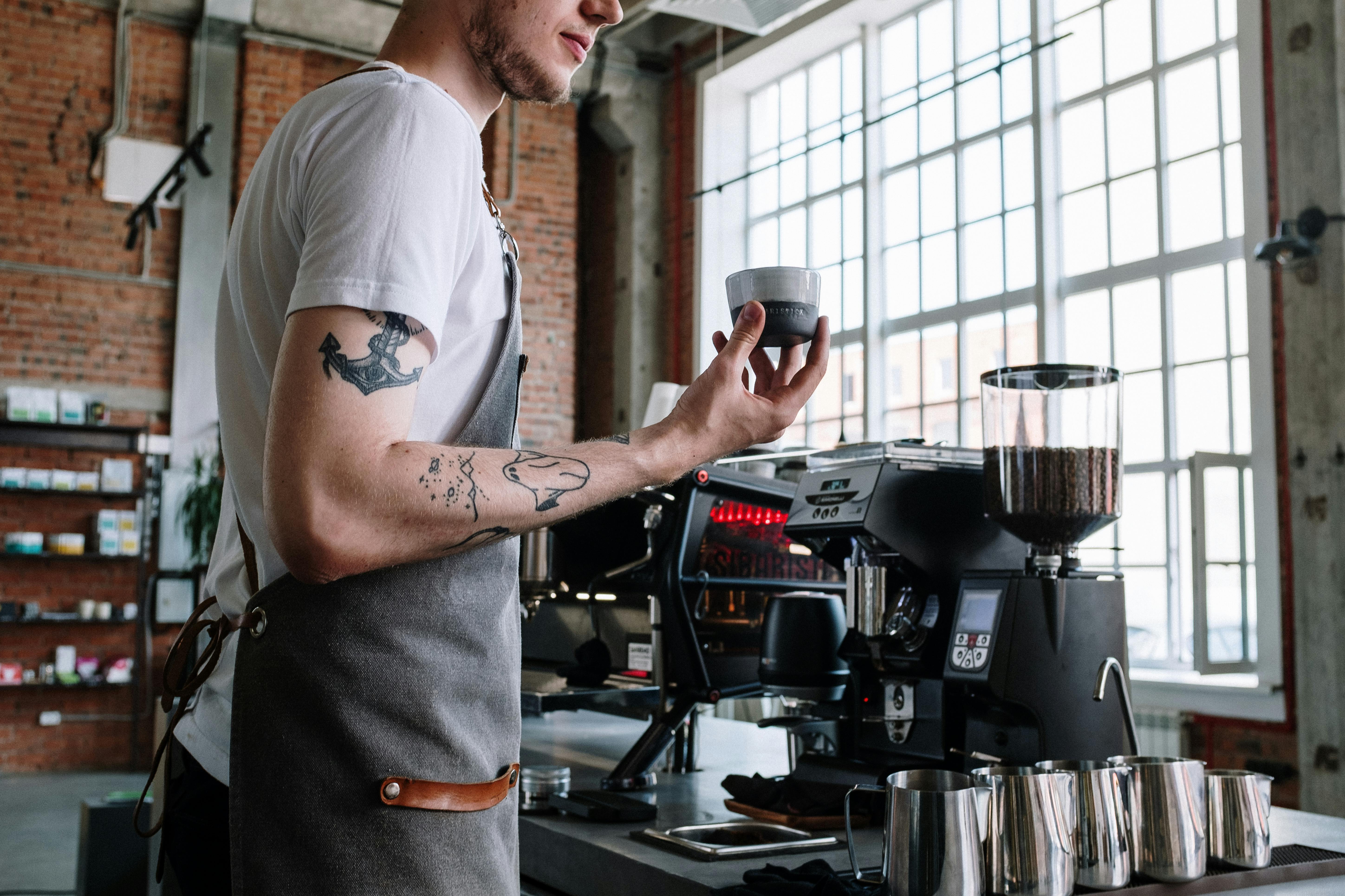 Barista behind a coffee counter wearing sunglasses