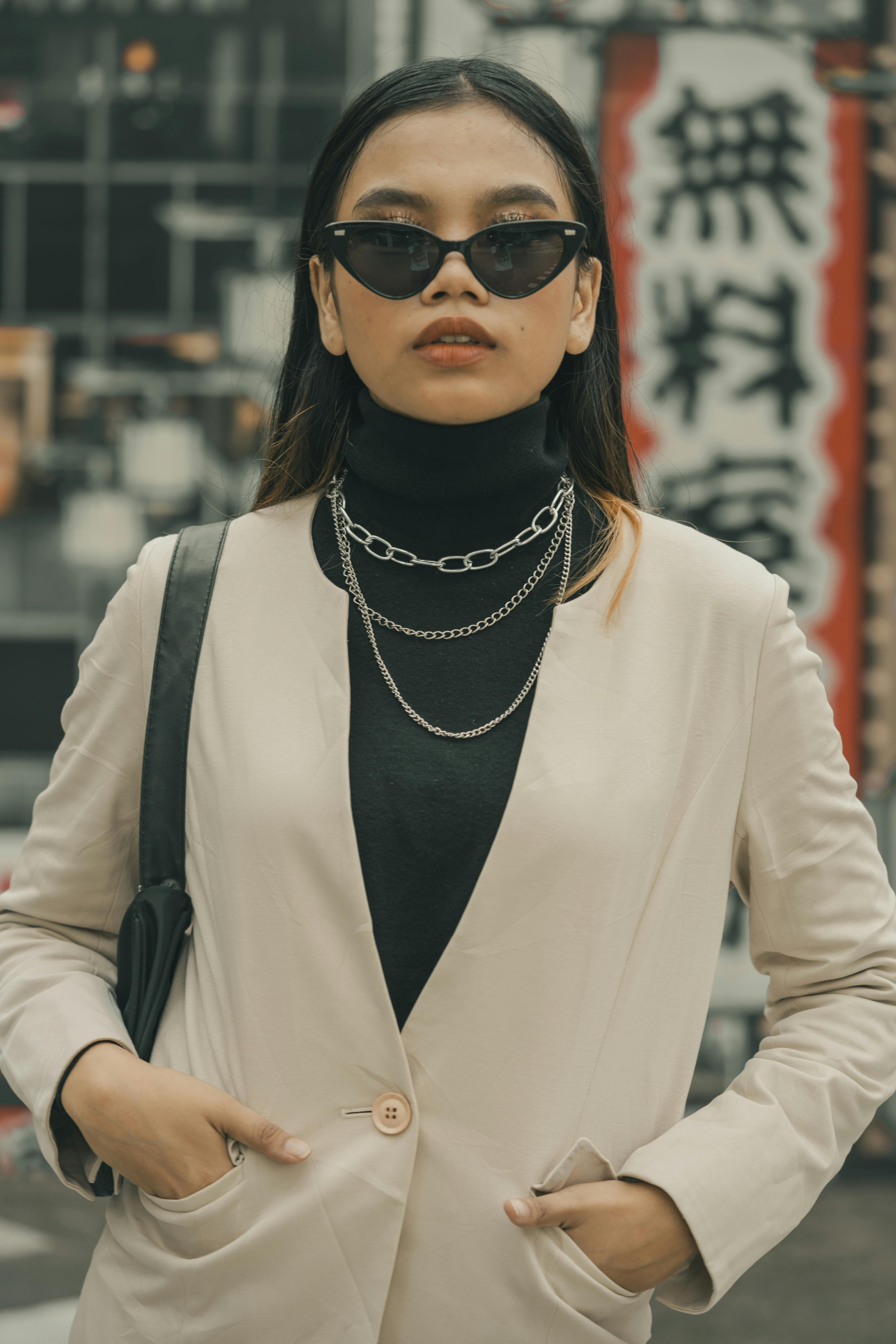 Woman with sunglasses styled with a casual outfit on a street
