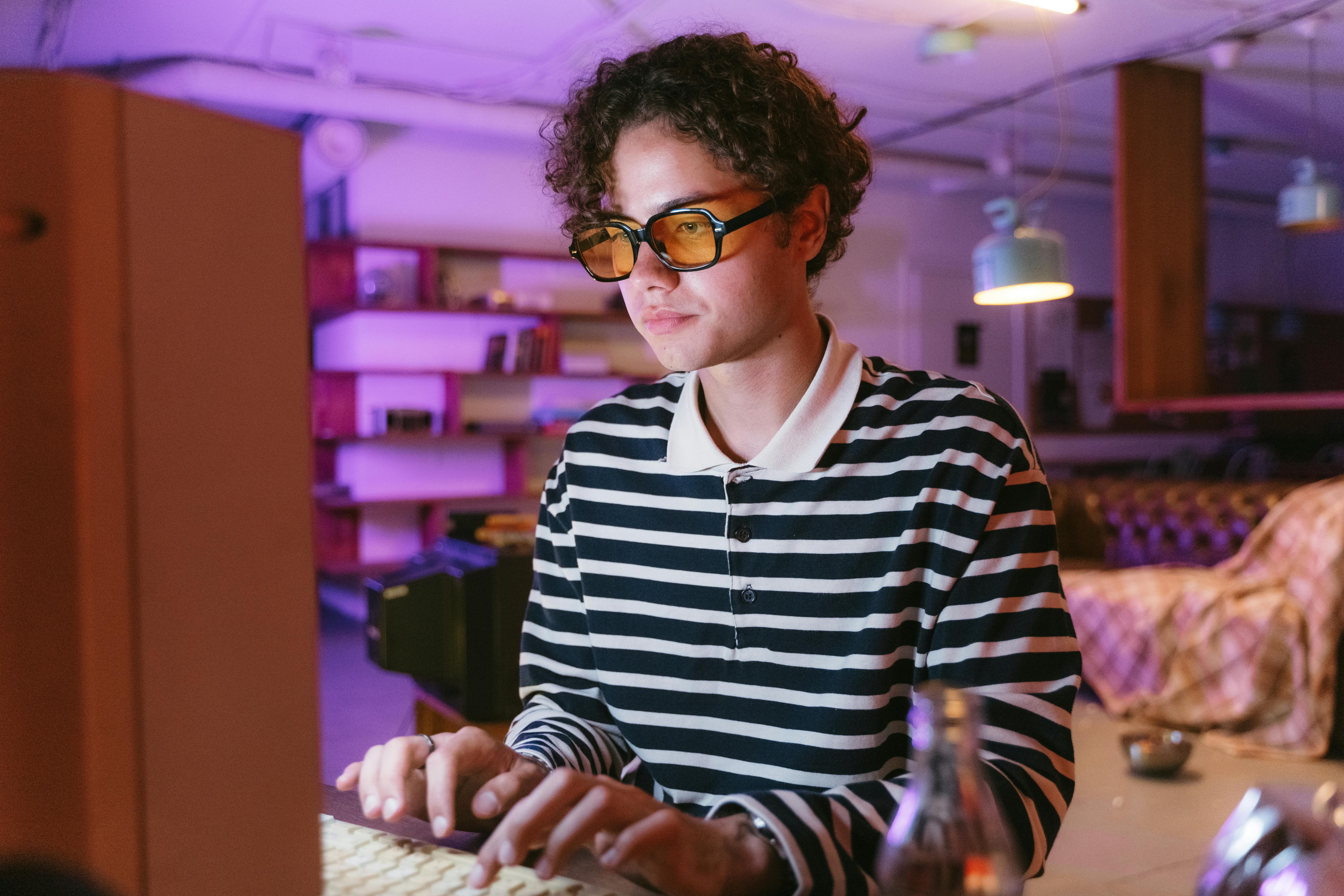 Person wearing light-tinted glasses inside a café