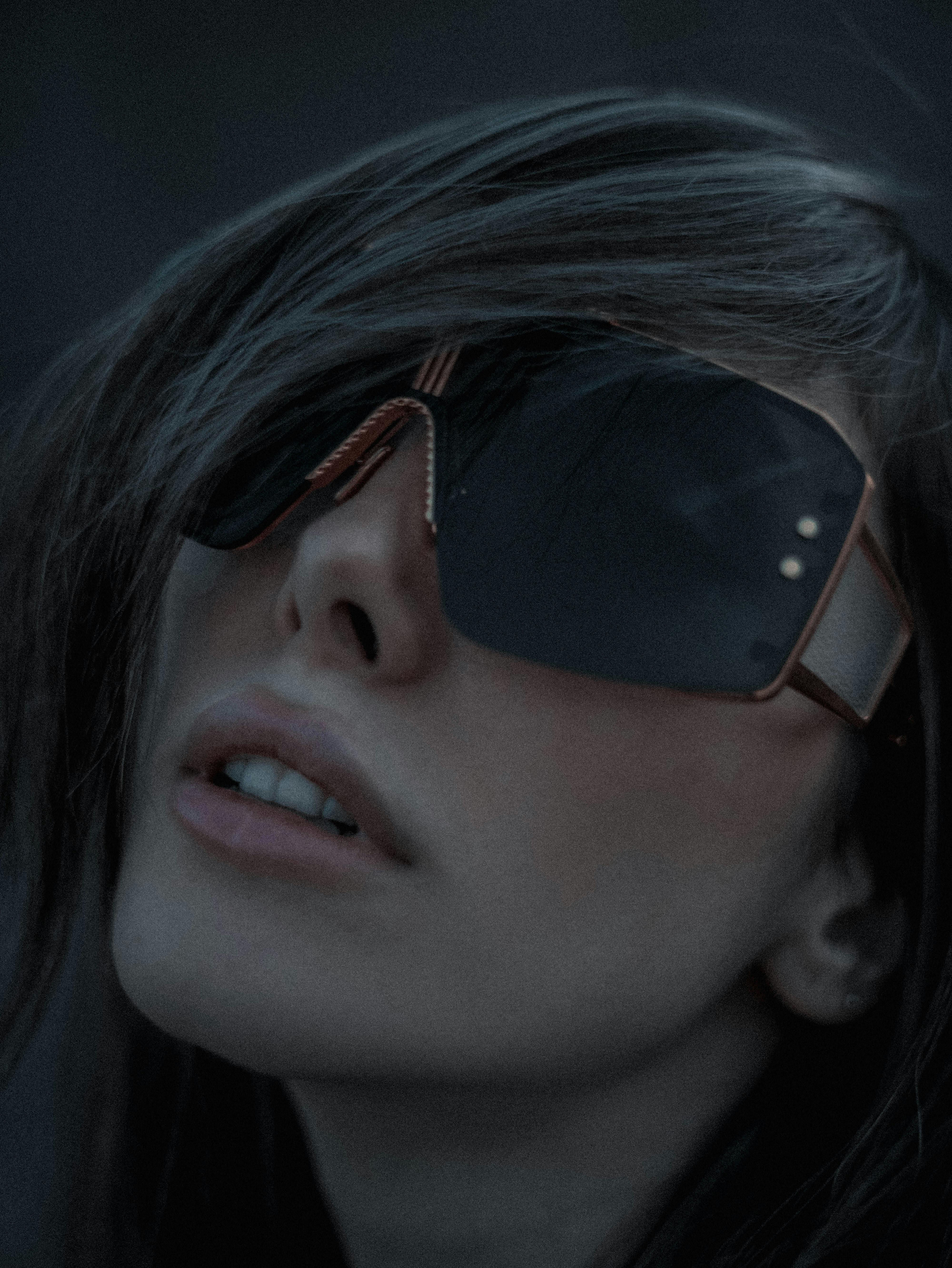 Close-up of a person with a small face wearing well-fitted sunglasses